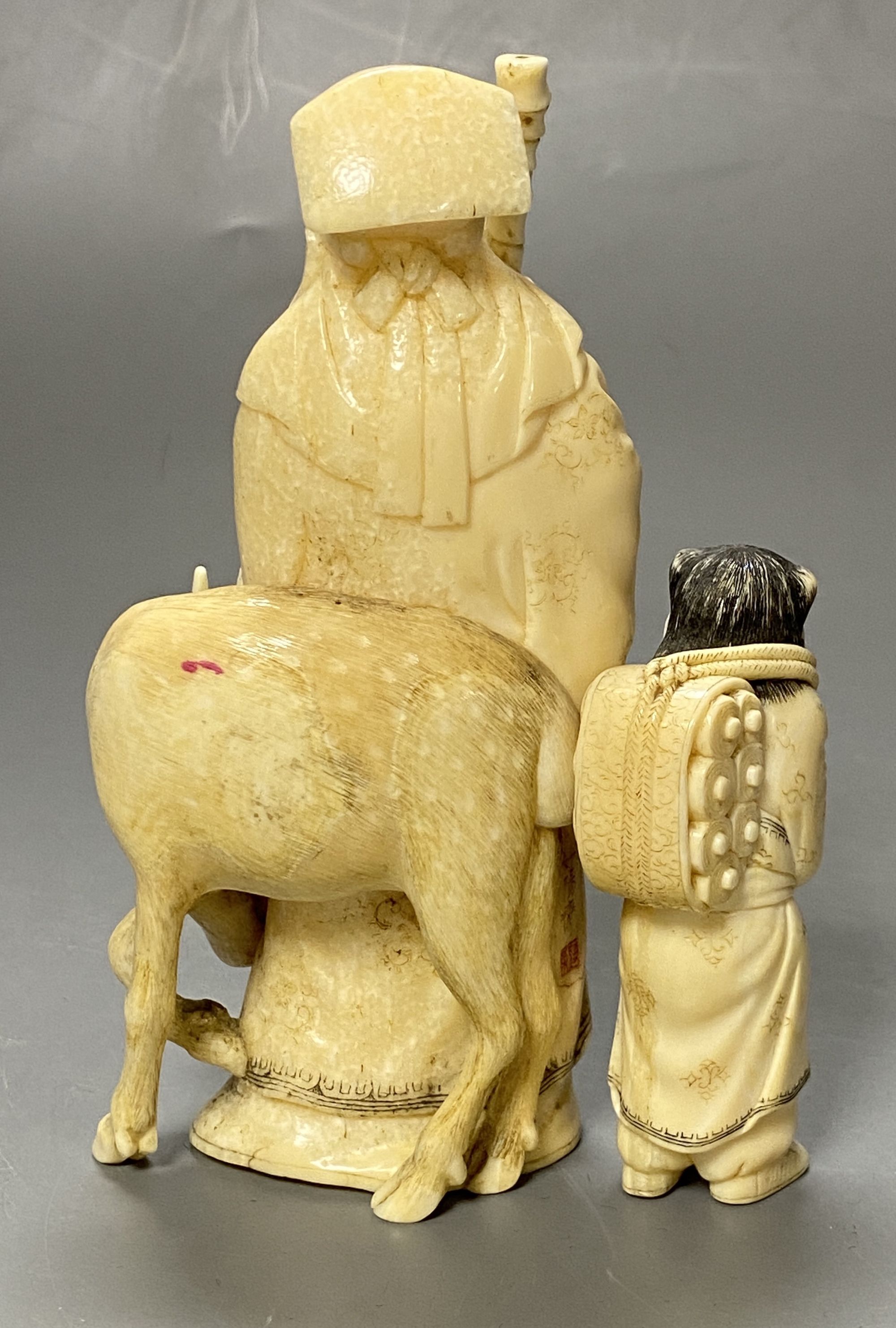 A Japanese ivory group of a man and deer, Meiji period, height 13cm,